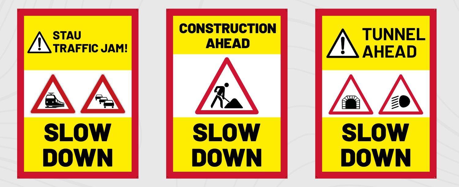 Drei Warntafeln: Stau/Traffic Jam, Construction ahead und Tunnel ahead – jeweils mit Slow down